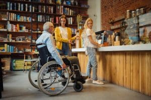 Adult disabled man in wheelchair, queue for coffee