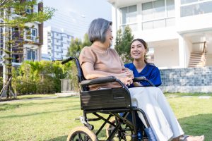 Asian happy senior woman patient sitting on wheelchair